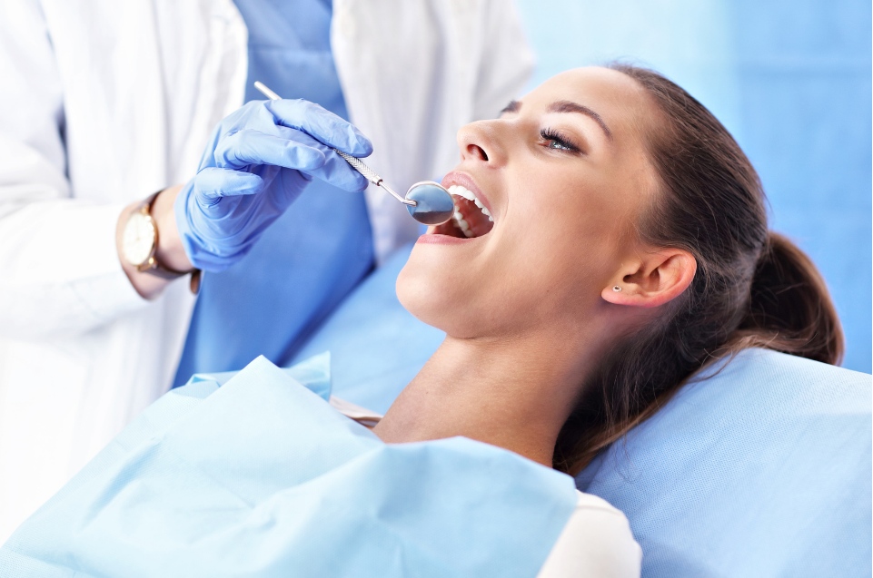 Dentist checking patient's teeth